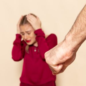 front-view-young-female-red-shirt-suffers-from-physical-violence-cream-space-female-cloth-photo